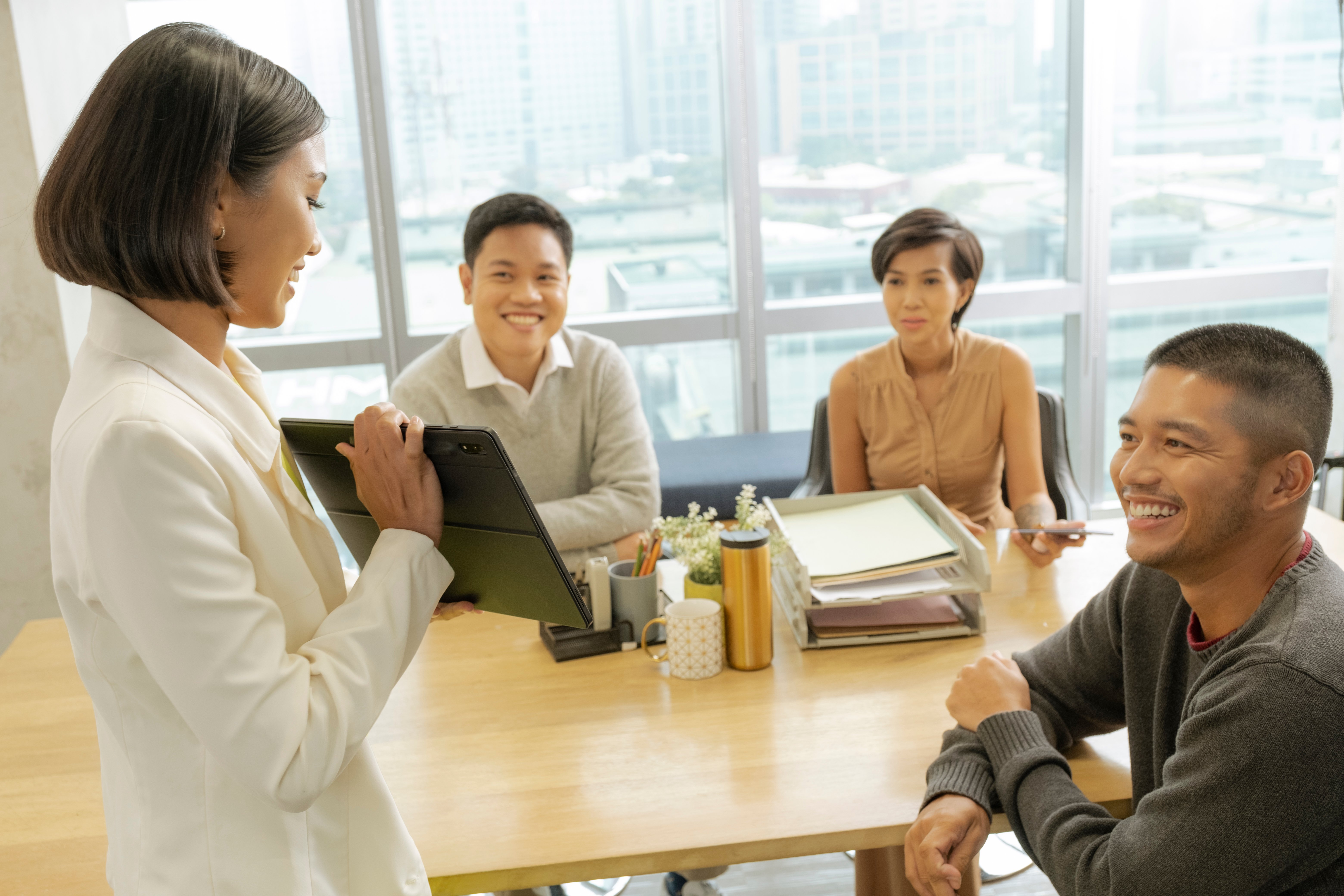 woman presenting in front of team