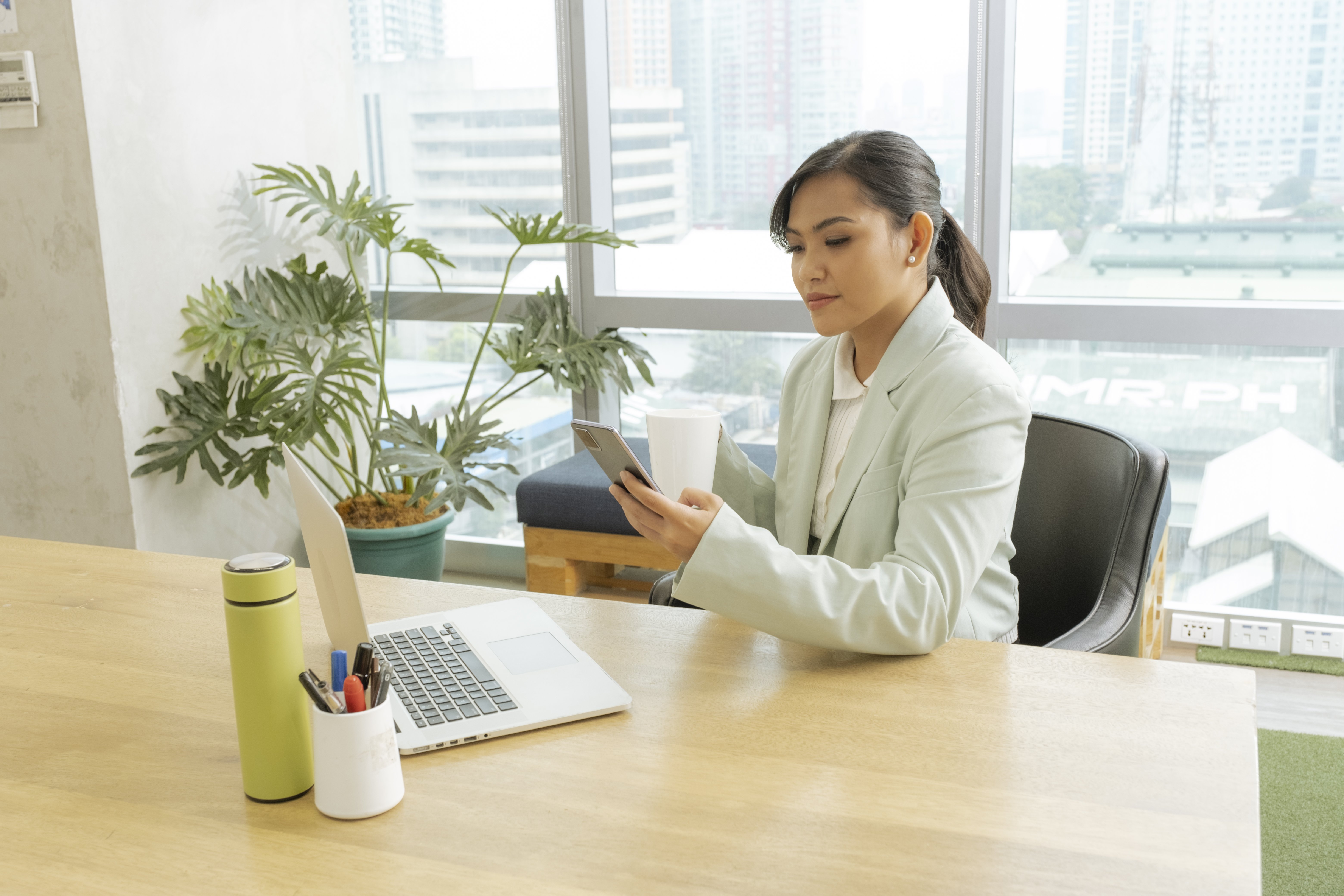 lady using phone in her office table