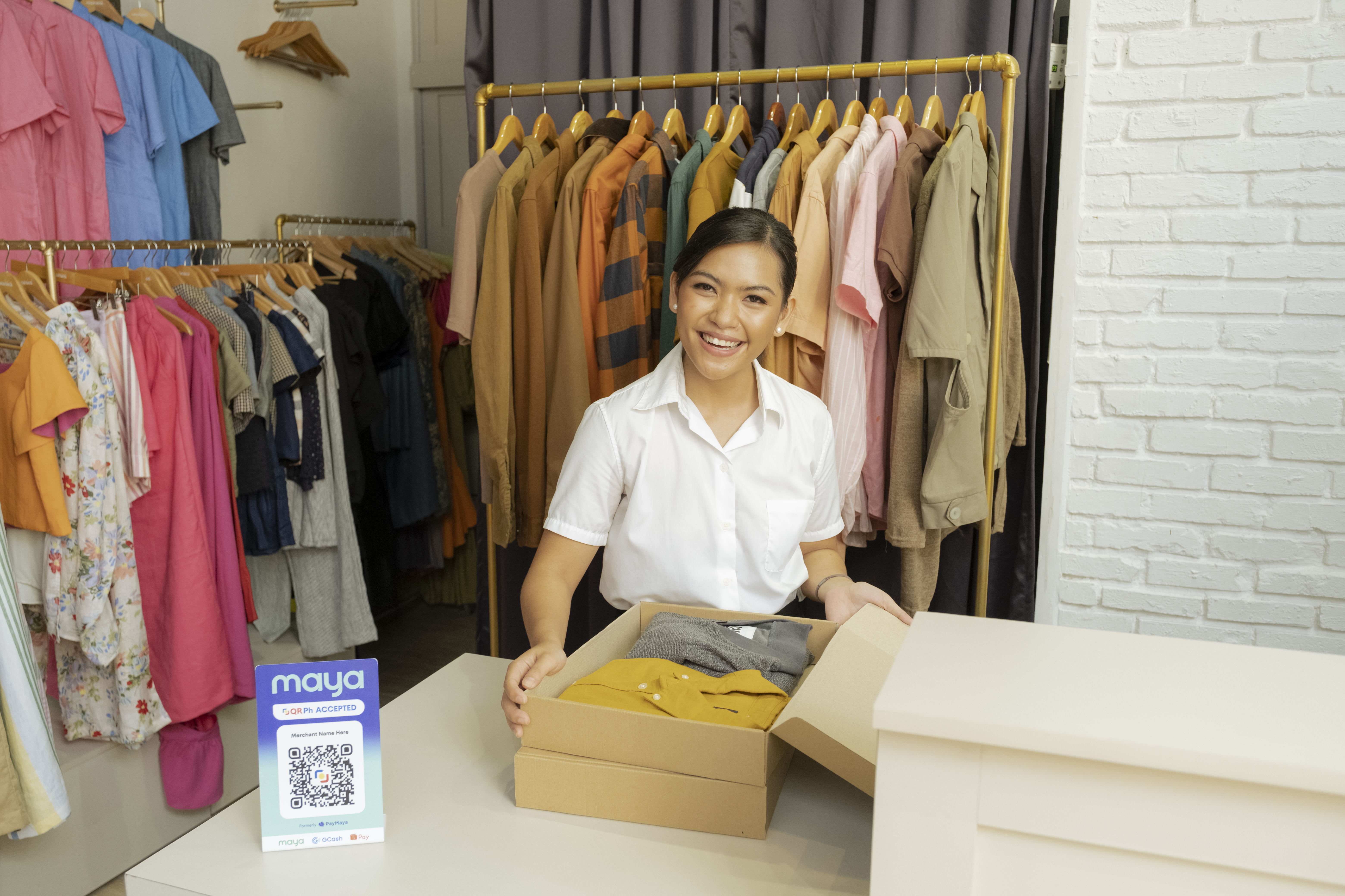 seller showing dress in box